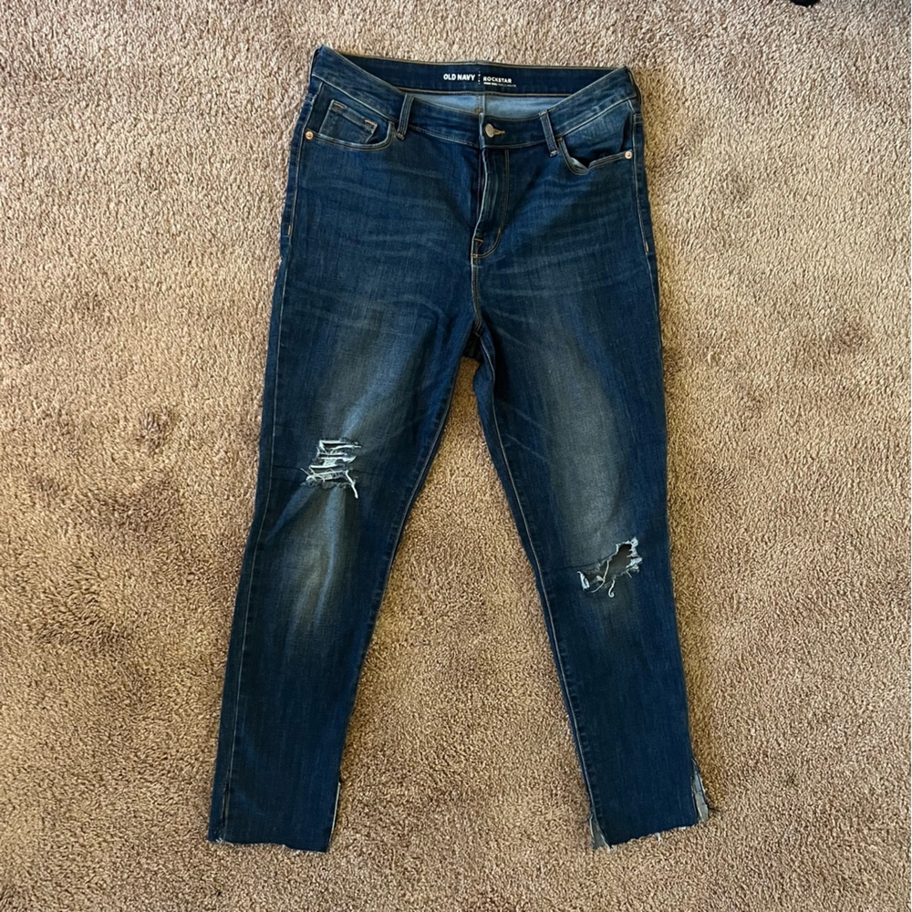 High Rise dark wash skinny jeans with a distressed look.